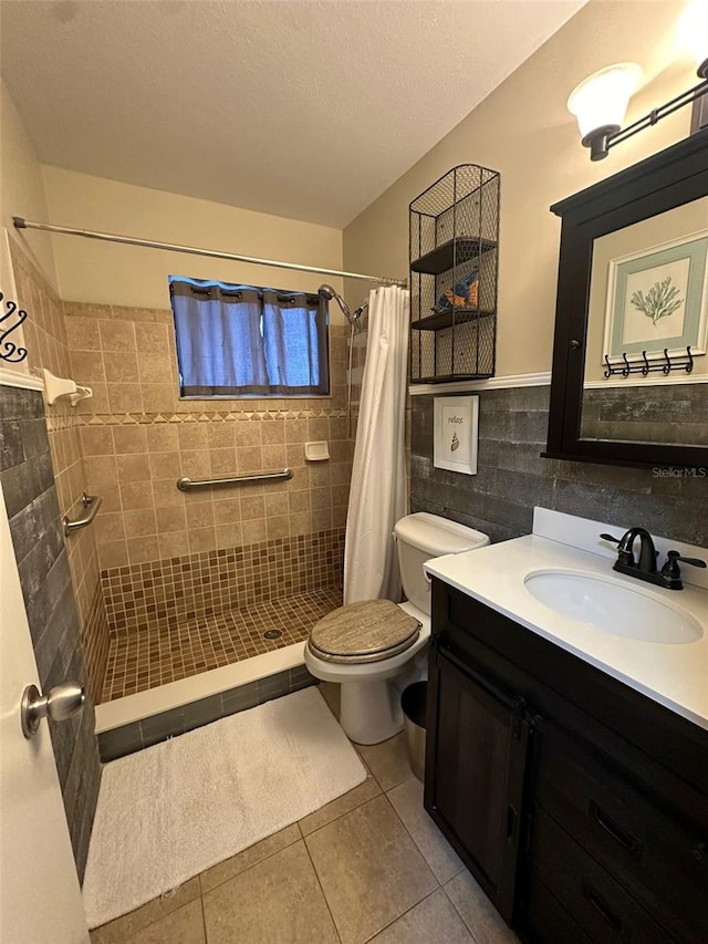 bathroom featuring tile patterned floors, a shower with curtain, vanity, tile walls, and toilet