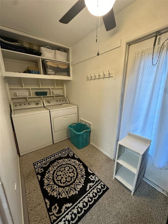 clothes washing area featuring washer and clothes dryer, ceiling fan, and carpet