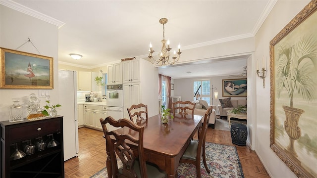 dining space with crown molding, light parquet flooring, and a notable chandelier