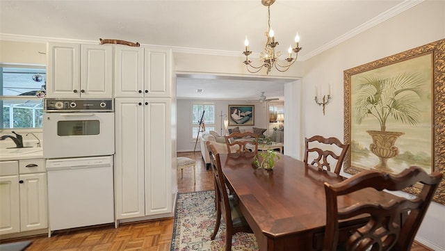 dining area with ceiling fan with notable chandelier, light parquet flooring, crown molding, and sink