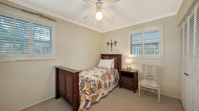 carpeted bedroom featuring a closet, ceiling fan, and ornamental molding