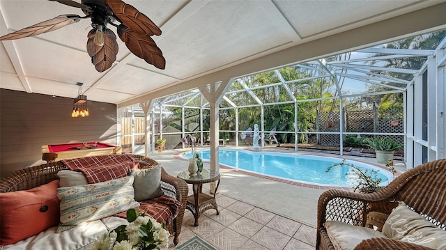 view of pool featuring glass enclosure and a patio area