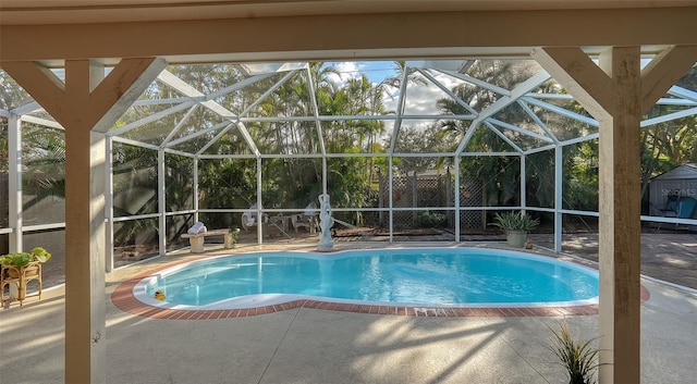 view of swimming pool featuring a patio and glass enclosure