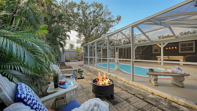 view of pool featuring a patio, glass enclosure, and a hot tub