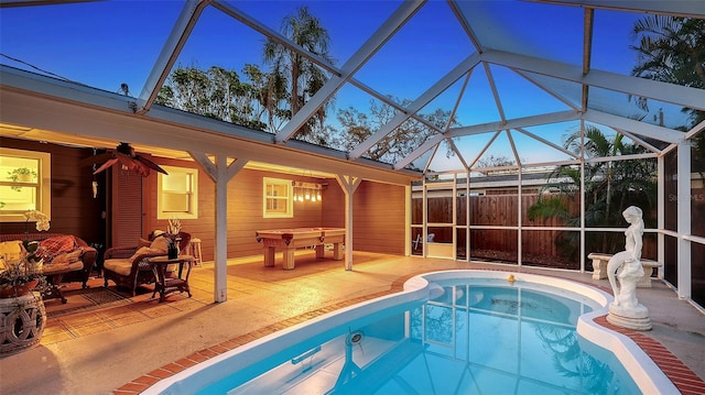 view of swimming pool with a patio, a jacuzzi, fence, and a lanai