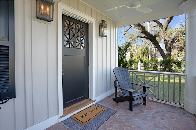 doorway to property with covered porch and ceiling fan