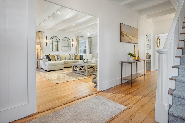 living room featuring hardwood / wood-style floors and beam ceiling