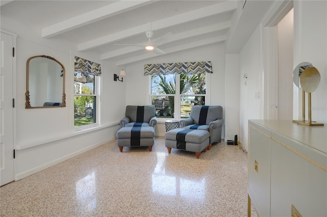 living area featuring lofted ceiling with beams and ceiling fan