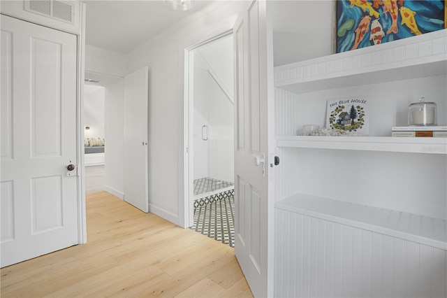 hall with hardwood / wood-style floors