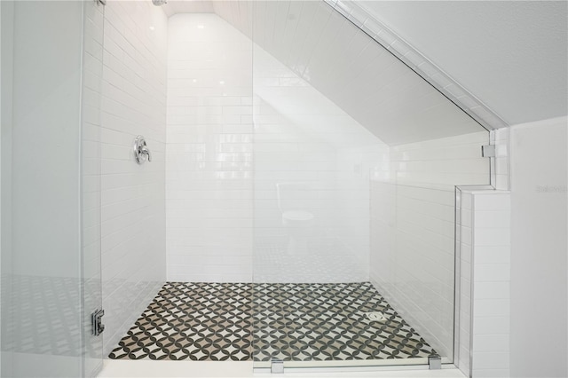 bathroom featuring lofted ceiling and an enclosed shower