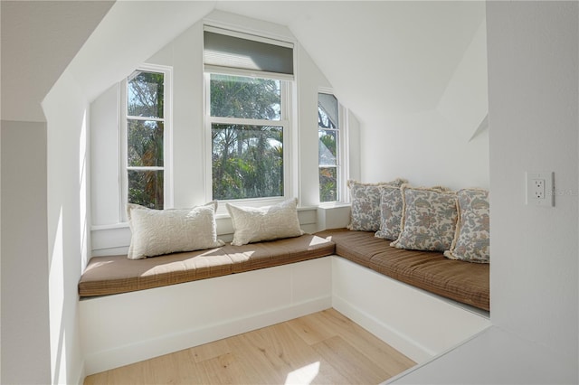 unfurnished room featuring lofted ceiling and hardwood / wood-style flooring