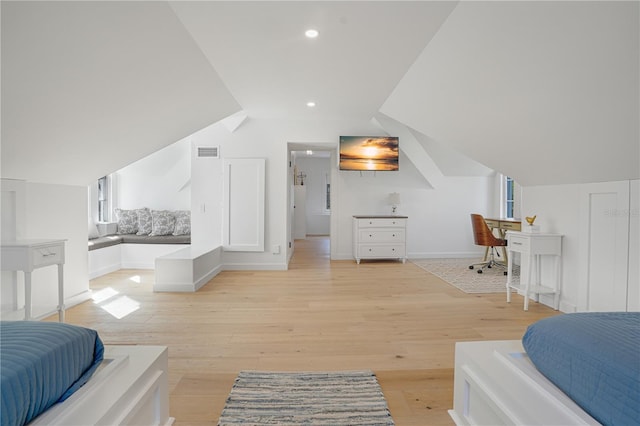 bedroom with lofted ceiling and light hardwood / wood-style flooring