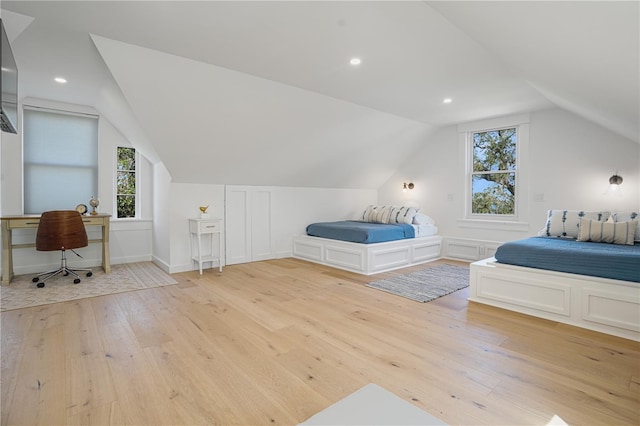 bedroom featuring light hardwood / wood-style floors and vaulted ceiling