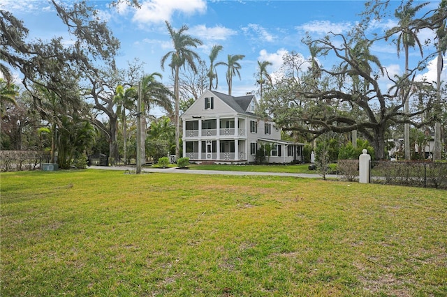 back of house featuring a yard and a sunroom