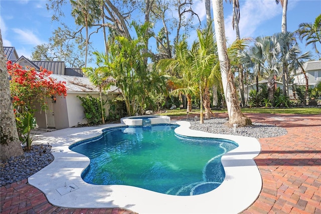 view of swimming pool with a patio and an in ground hot tub