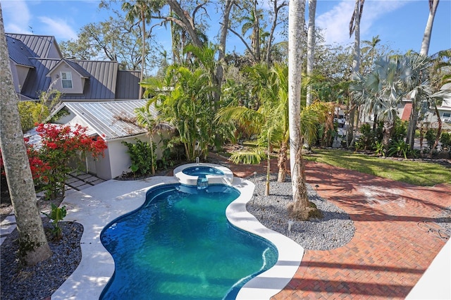 view of swimming pool featuring a patio and an in ground hot tub