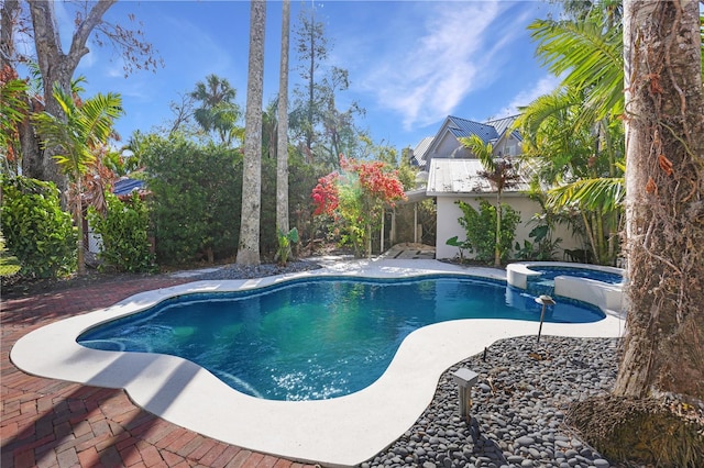 view of pool with an in ground hot tub