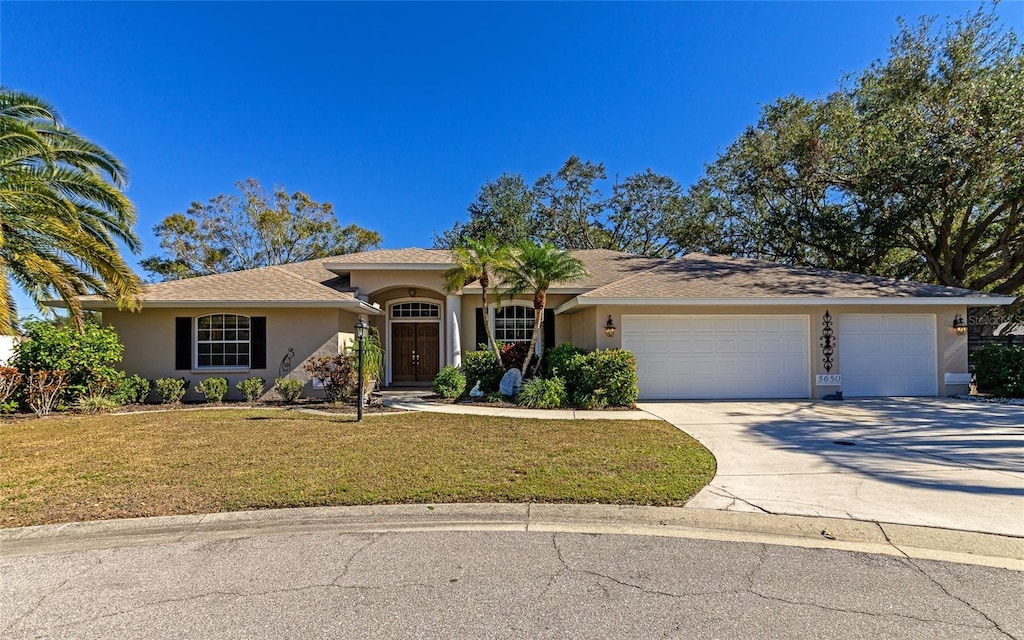 single story home with a front lawn and a garage