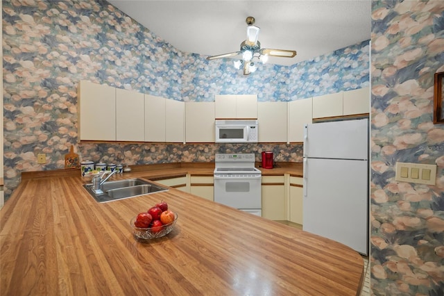 kitchen featuring white appliances, ceiling fan, sink, light hardwood / wood-style flooring, and white cabinets