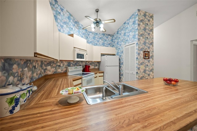 kitchen with tasteful backsplash, white appliances, ceiling fan, sink, and white cabinetry