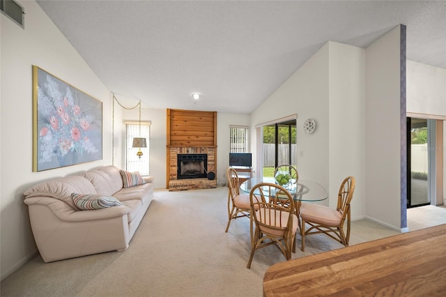 carpeted dining area with lofted ceiling