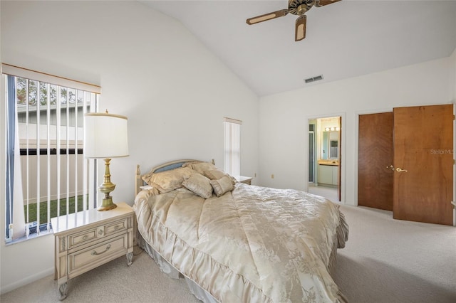 bedroom featuring ensuite bathroom, vaulted ceiling, ceiling fan, and light colored carpet