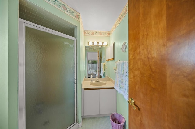 bathroom featuring tile patterned flooring, vanity, and a shower with door