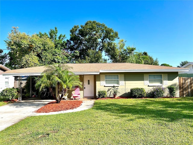 ranch-style house featuring a front yard and a carport