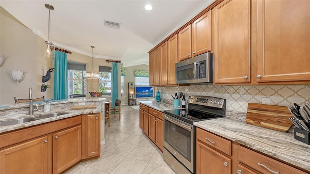 kitchen featuring appliances with stainless steel finishes, hanging light fixtures, ornamental molding, light stone counters, and sink