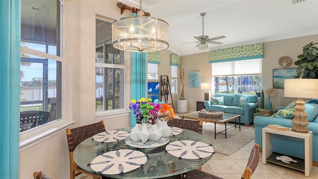 tiled dining room with ornamental molding, a water view, vaulted ceiling, and ceiling fan with notable chandelier