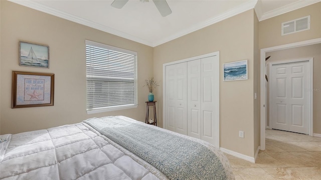 bedroom featuring ceiling fan, ornamental molding, a closet, and light tile patterned floors