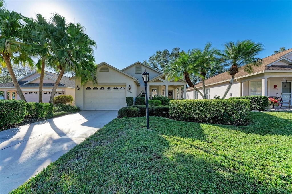 ranch-style home with a garage and a front yard