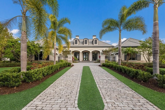 view of building exterior with decorative driveway