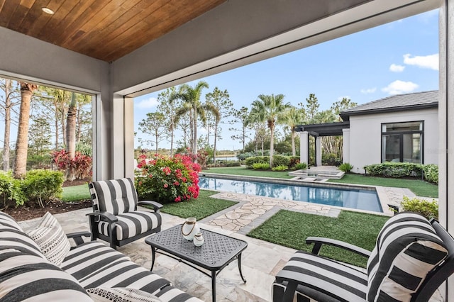 view of patio / terrace with a pool with hot tub