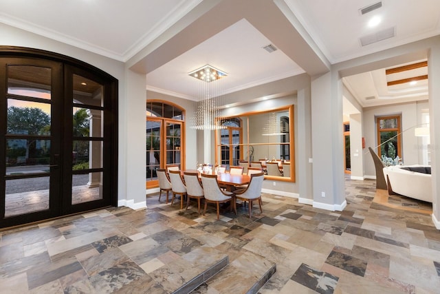 unfurnished dining area with french doors, crown molding, and an inviting chandelier