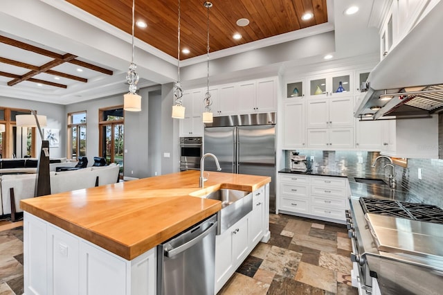 kitchen with stainless steel appliances, an island with sink, white cabinetry, and island exhaust hood