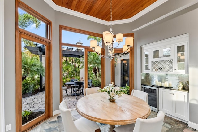 dining area with a wealth of natural light, beverage cooler, wood ceiling, and an inviting chandelier