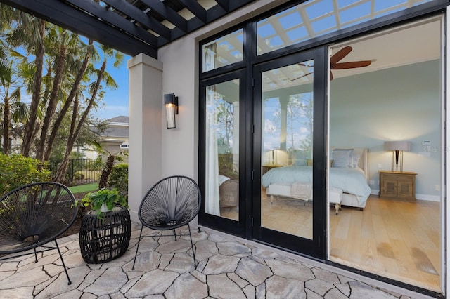 view of exterior entry with a patio, french doors, and a pergola