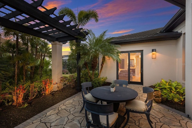 patio terrace at dusk with a pergola