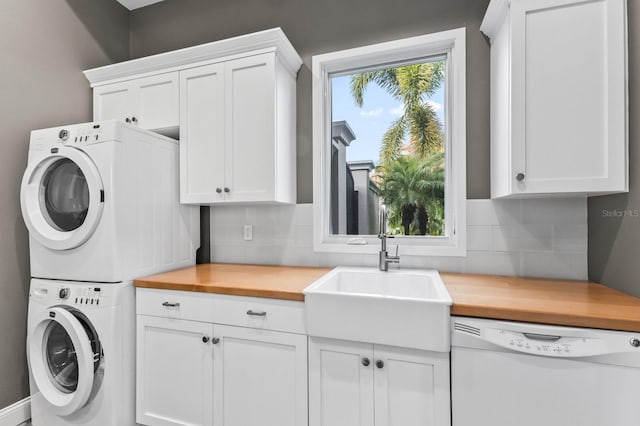 laundry room featuring sink and stacked washer and dryer