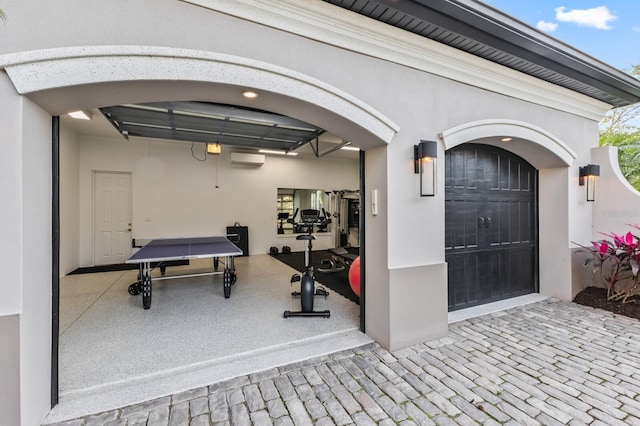 garage featuring a wall mounted air conditioner