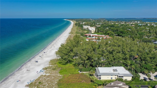 birds eye view of property featuring a water view and a beach view