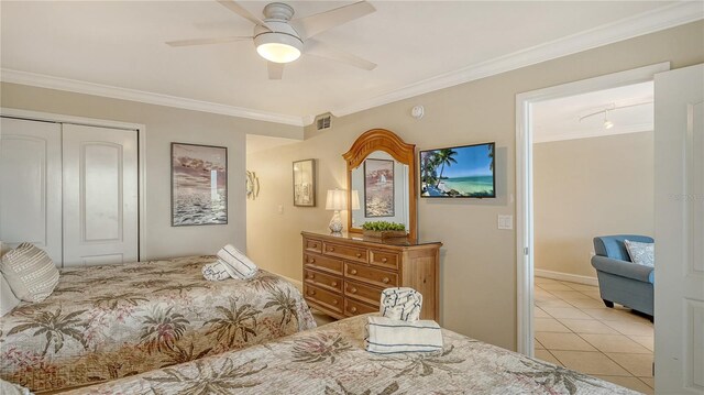5311 Gulf Of Mexico Dr Unit 3, Longboat Key, FL 34228 - bedroom featuring a closet, tile patterned floors, ornamental molding, and ceiling fan