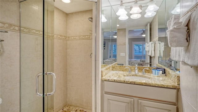 5311 Gulf Of Mexico Dr Unit 3, Longboat Key, FL 34228 - ensuite bathroom with a shower stall, vanity, and ceiling fan