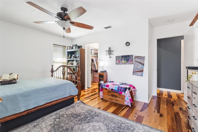 bedroom featuring ceiling fan, a closet, and wood-type flooring