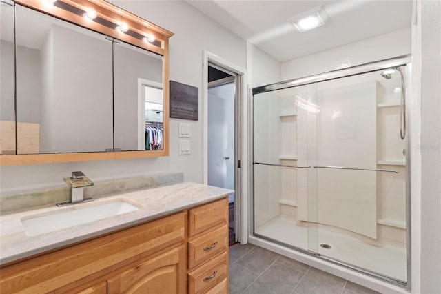 bathroom with tile patterned flooring, vanity, and an enclosed shower