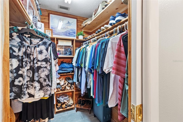 walk in closet with tile patterned flooring