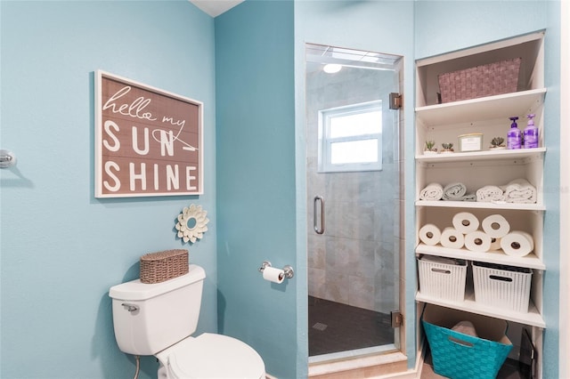 bathroom featuring toilet and an enclosed shower