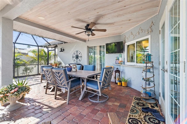 view of patio with ceiling fan and a lanai