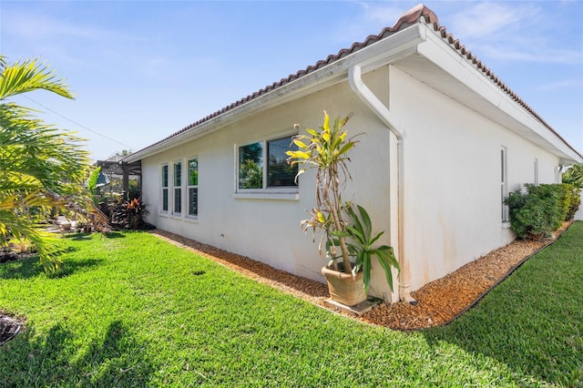 view of property exterior with a lawn